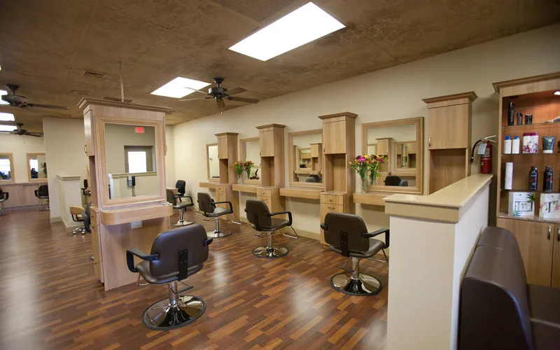 The styling floor, with chairs facing mirrored stations and shelves of hair products along the right-hand wall.